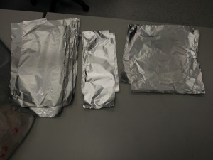 Pieces of aluminum foil in three sizes