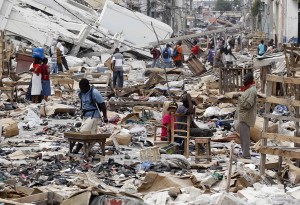 Residents walk in a destroyed area after a major earthquake hit the Haitian capital Port-au-Prince