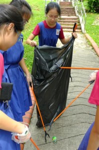 Students from CHIJ St. Nic's Girls' school picking up litter