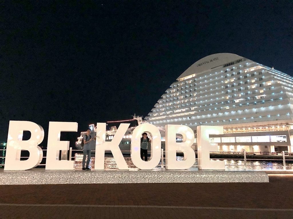 Samuel Loo posing with the 'BE KOBE' monument at the Meriken Park in Kobe, Japan.